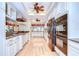 Gourmet kitchen featuring white cabinets, stainless steel appliances, granite countertops, and hardwood floors at 124 Barrington Dr, Brandon, FL 33511