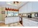 Bright kitchen featuring white cabinetry, granite countertops, and a charming window valance at 124 Barrington Dr, Brandon, FL 33511