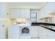 Laundry room features washer and dryer, white cabinets, and sink at 124 Barrington Dr, Brandon, FL 33511