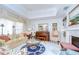 Cozy living room with marble floors, a fireplace, comfortable seating, and natural light from the window at 124 Barrington Dr, Brandon, FL 33511