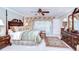 Beautifully appointed main bedroom with a four-poster bed, elegant furnishings, and soft lighting at 124 Barrington Dr, Brandon, FL 33511