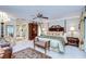 Luxurious main bedroom with a four-poster bed, ample natural light, and en-suite bathroom access at 124 Barrington Dr, Brandon, FL 33511
