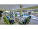 A relaxing outdoor patio area with comfortable seating, ceiling fans, and views of the pool at 124 Barrington Dr, Brandon, FL 33511