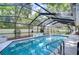 Sparkling screened pool features mosaic details, with lush backyard landscape and serene privacy wall at 124 Barrington Dr, Brandon, FL 33511