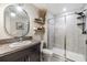 Modern bathroom featuring a walk-in shower with glass doors and gray tiles at 1594 Cassius St, Lutz, FL 33549