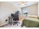 Bedroom featuring a ceiling fan, desk, dresser, and comfortable bed at 1594 Cassius St, Lutz, FL 33549