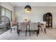 Dining room features a wooden table, seating for six, and modern black hutch at 1594 Cassius St, Lutz, FL 33549
