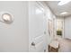Hallway view with a smart thermostat, interior doors, and a small bench seat at 1594 Cassius St, Lutz, FL 33549
