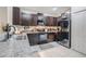 Kitchen featuring dark cabinets, stainless appliances, granite countertops, and tile floors at 1594 Cassius St, Lutz, FL 33549