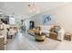Bright, tiled living room with modern decor, an open layout, and contemporary furnishings at 1594 Cassius St, Lutz, FL 33549