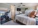 Well-lit main bedroom with an exercise bike, television, and a large bed at 1594 Cassius St, Lutz, FL 33549