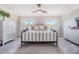 Spacious main bedroom with modern ceiling fan, two windows and decorative decor at 1594 Cassius St, Lutz, FL 33549