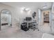 Upstairs office space with carpeted floors and view into adjacent bedrooms at 1594 Cassius St, Lutz, FL 33549