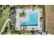 Aerial view of a community pool with ample lounge chairs and lush landscaping at 1594 Cassius St, Lutz, FL 33549