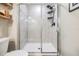 Clean and modern glass-enclosed shower with white tile and black fixtures at 1594 Cassius St, Lutz, FL 33549