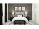 Elegantly styled bedroom with a gray upholstered headboard, decorative pillows, and sophisticated black and white accents at 16983 Falling Waters Ct, Land O Lakes, FL 34638