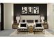 Stylish bedroom with modern decor, a plush bed, and black and white accents at 16983 Falling Waters Ct, Land O Lakes, FL 34638