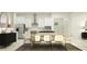 Bright, open kitchen and dining area with white cabinetry, stainless steel appliances, and ample seating at 16983 Falling Waters Ct, Land O Lakes, FL 34638