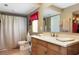 Bathroom featuring a large vanity with double sinks, a curtained shower, and a toilet at 1722 48Th N Ave, St Petersburg, FL 33714