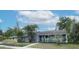 Inviting exterior view of a home with a well-maintained lawn and decorative plants, plus an inviting walkway at 1722 48Th N Ave, St Petersburg, FL 33714