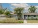 Charming single-story home with lush landscaping, including palm trees and a well-manicured lawn at 1722 48Th N Ave, St Petersburg, FL 33714