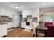 Functional kitchen space with white cabinets, updated appliances, and a dining area for convenience at 1722 48Th N Ave, St Petersburg, FL 33714