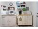 Kitchenette featuring white cabinets, stainless steel sink, and rolling island at 1722 48Th N Ave, St Petersburg, FL 33714
