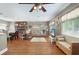 Cozy living room with a brick fireplace, hardwood floors, and a comfortable seating area with ample light at 1722 48Th N Ave, St Petersburg, FL 33714