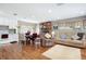 Open-concept living area featuring hardwood floors, a brick fireplace, and seamless flow to the kitchen at 1722 48Th N Ave, St Petersburg, FL 33714