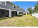 View of a well-maintained backyard featuring a screened porch and a privacy fence at 2140 Laceflower Dr, Brandon, FL 33510