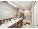 Bright bathroom featuring a double sink vanity, a large mirror, and a glass-enclosed shower, creating a spa-like retreat at 2140 Laceflower Dr, Brandon, FL 33510