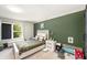 Cozy bedroom featuring a light color palette and a unique green accent wall, providing a relaxing and inviting atmosphere at 2140 Laceflower Dr, Brandon, FL 33510