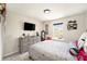 Comfortable bedroom featuring a dresser with a TV and a window overlooking the neighborhood, creating a relaxing retreat at 2140 Laceflower Dr, Brandon, FL 33510