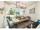 Dining room with a wooden table, cushioned seating, and sliding glass doors leading to the patio at 2140 Laceflower Dr, Brandon, FL 33510