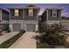 Front exterior of townhomes, showing garages and landscaping at 2140 Laceflower Dr, Brandon, FL 33510