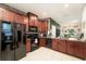 Kitchen with wooden cabinets, black appliances, and an open layout to the living space at 2140 Laceflower Dr, Brandon, FL 33510