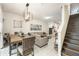 Open concept living area with a dining set, living room seating, and staircase at 2140 Laceflower Dr, Brandon, FL 33510