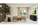 Bright living room with modern furniture, stylish decor, and views of the landscaped outdoors at 2274 Blue Grosbeak Pl, Wimauma, FL 33598