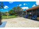 Charming backyard with a screened pool, outdoor seating, and a neatly arranged gravel area at 2436 Covington Ave, Spring Hill, FL 34608