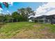 Large backyard with a screened-in pool area and well-maintained landscaping and lawn at 2436 Covington Ave, Spring Hill, FL 34608