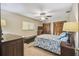 Bedroom with a ceiling fan, a large window, and wooden closet doors at 2436 Covington Ave, Spring Hill, FL 34608