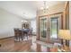 Formal dining room boasting wood floors, elegant lighting, and decorative glass front door at 2436 Covington Ave, Spring Hill, FL 34608