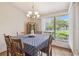 Bright dining room features a large window with natural light and cozy chandelier at 2436 Covington Ave, Spring Hill, FL 34608