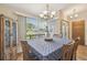 Inviting dining area with bright window views, cabinet, and an elegant chandelier at 2436 Covington Ave, Spring Hill, FL 34608