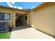 Exterior view of a covered patio with access doors, storage, and AC unit at 2436 Covington Ave, Spring Hill, FL 34608