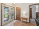 Inviting foyer featuring elegant front doors, wood floors, and a view into adjacent rooms at 2436 Covington Ave, Spring Hill, FL 34608