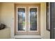 Elegant double front doors with patterned glass detailing, set within a tan-colored exterior at 2436 Covington Ave, Spring Hill, FL 34608