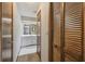 Hallway leading to the bathroom with a linen closet at 2436 Covington Ave, Spring Hill, FL 34608