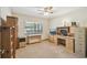 Home office featuring a built-in desk, a window, and carpeted floors at 2436 Covington Ave, Spring Hill, FL 34608