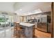 Bright kitchen with stainless steel appliances, a breakfast bar, and access to the outdoor pool at 2436 Covington Ave, Spring Hill, FL 34608